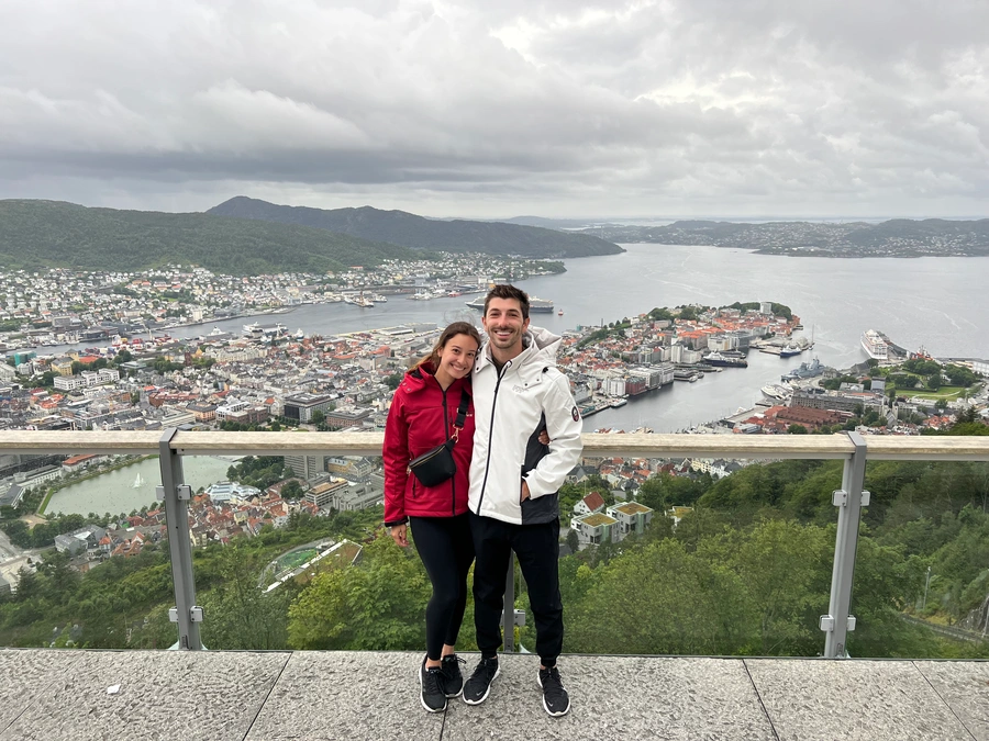 Carolina and Griffin at a scenic vista with the city of Bergen in the background.
