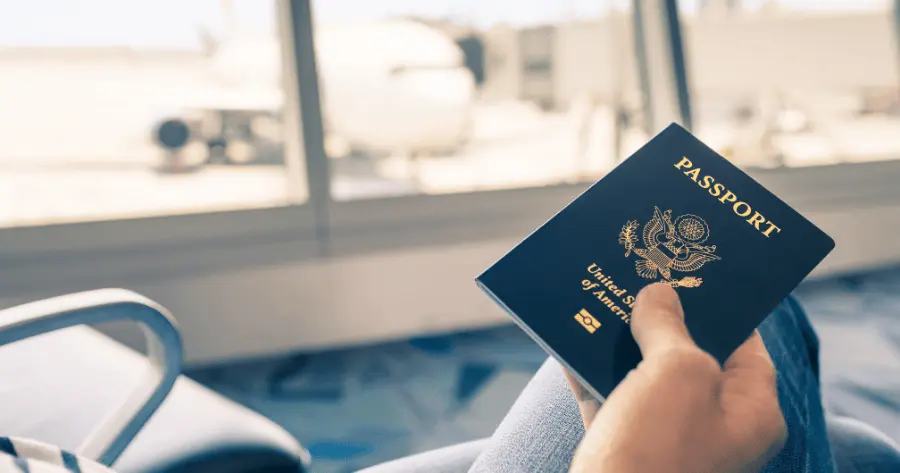 Woman grabs her passport to pack safely for her solo travel trip