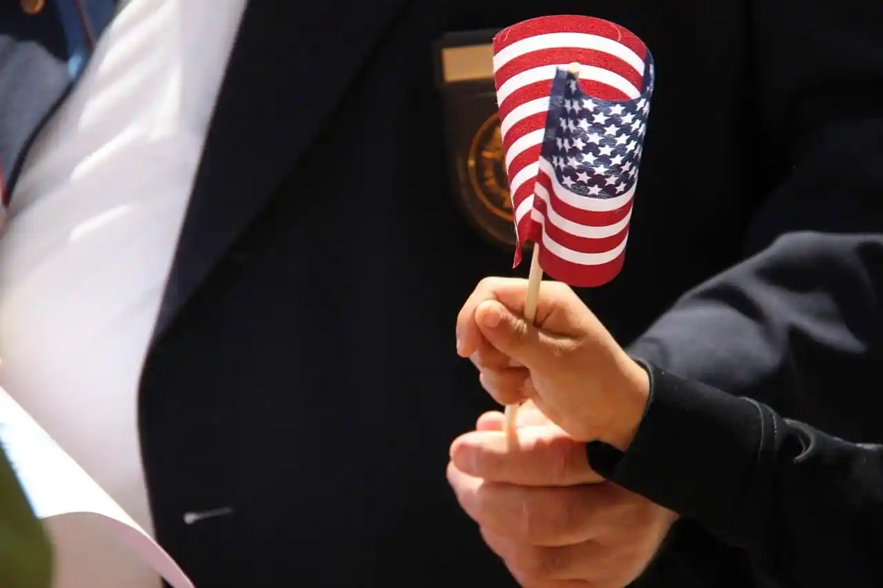 hands holding a small American flag
