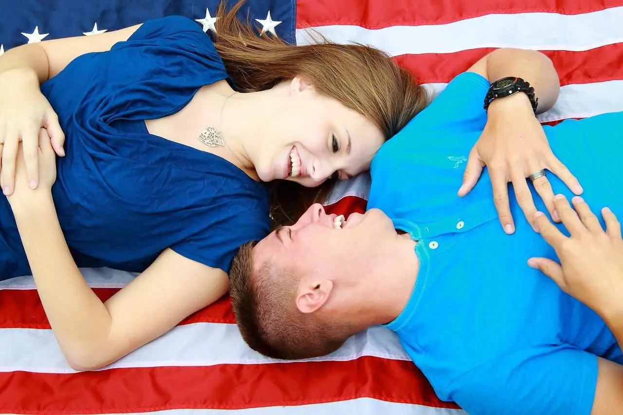 couple laying on a blanket with an image of the stars and stripes on it
