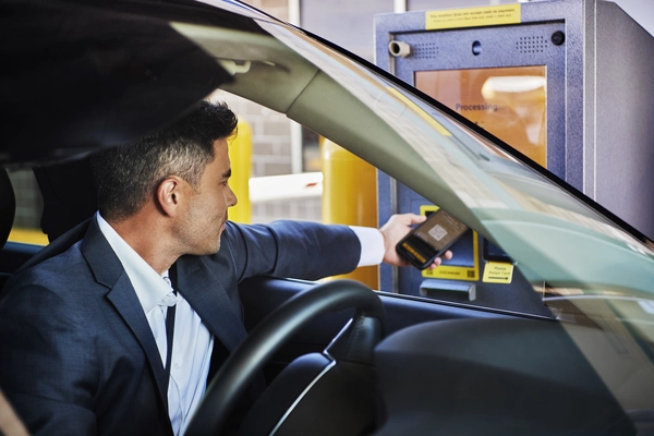 driver scans qr code at the parking spot entry kiosk